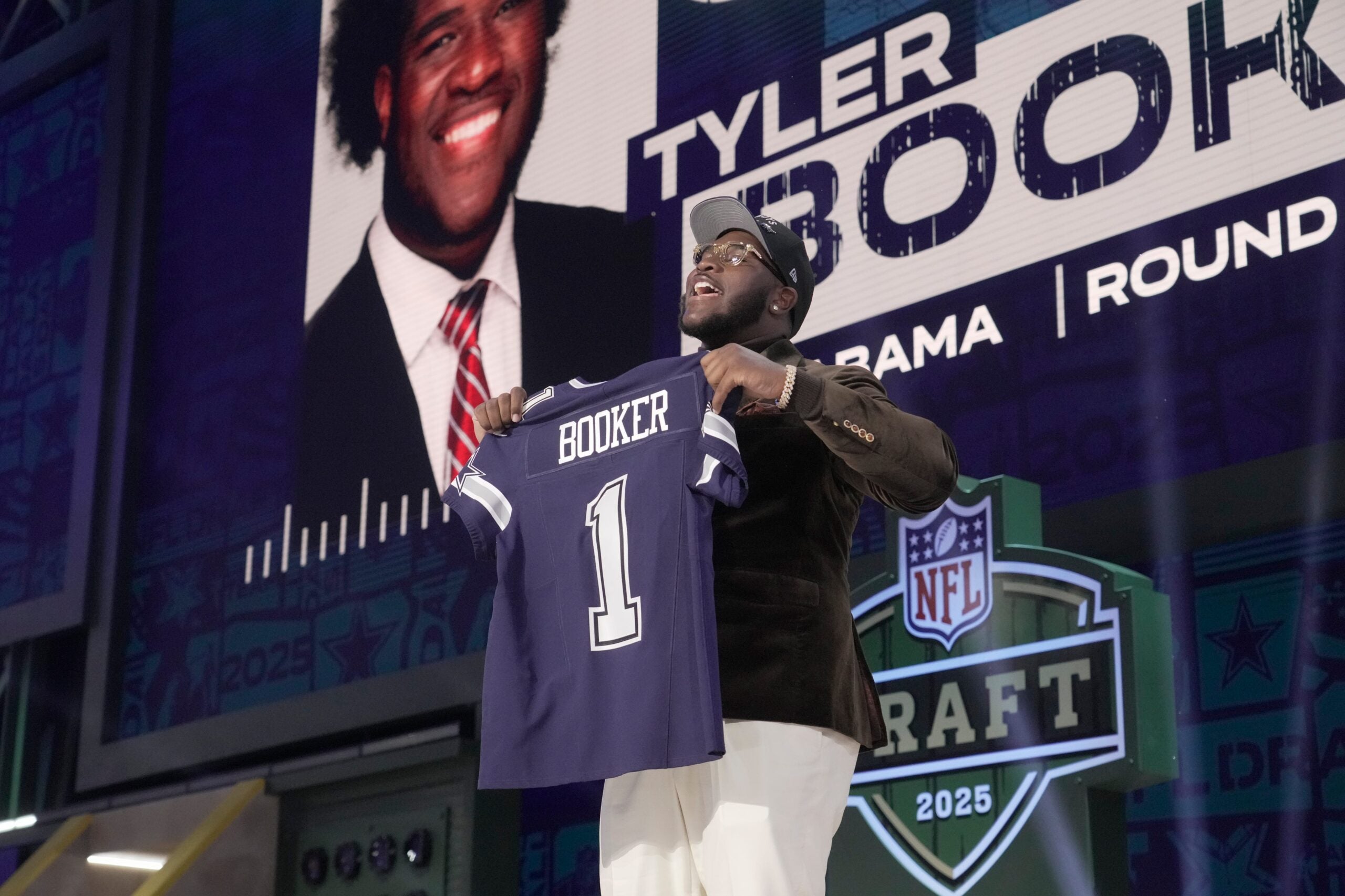 Alabama Crimson Tide offensive lineman Tyler Booker poses with NFL commissioner Roger Goodell after he is selected by the Dallas Cowboys as the number twelve pick in the first round of the 2025 NFL Draft at Lambeau Field.