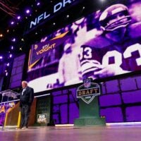 Former Minnesota Vikings tight end Stu Voigt announces the team’s selection with the 102nd overall pick during the third round of the 2025 NFL Draft on Friday, April 25, 2025, at Lambeau Field in Green Bay, Wisconsin. The draft runs through April 26.