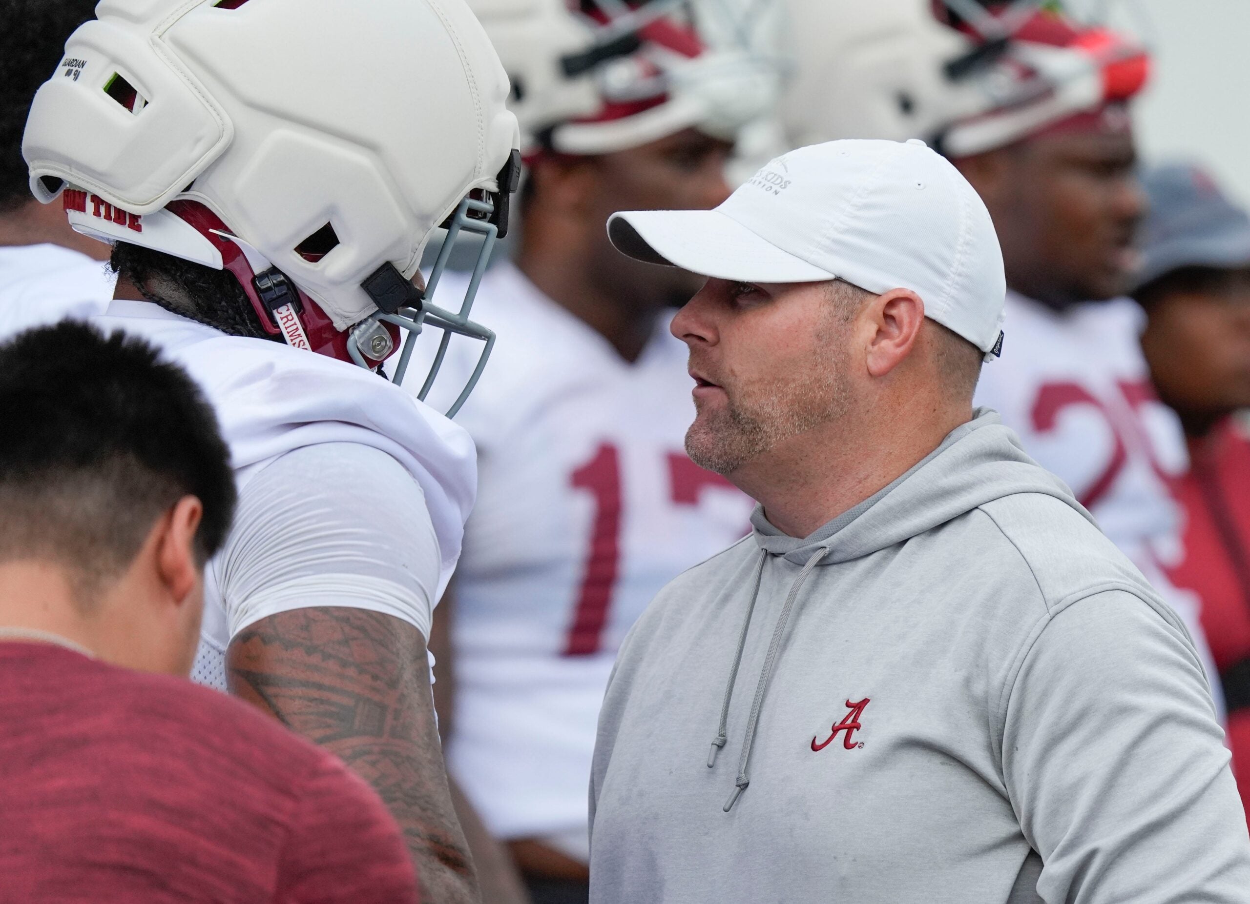 July 30, 2025; Tuscaloosa, AL, USA; Defensive coordinator Kane Wommack talks to defensive lineman London Simmons during the first practice session of the preseason for the Alabama Crimson Tide.