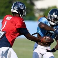 Tennessee Titans quarterback Cam Ward (1) hands the ball off to wide receiver Calvin Ridley (0) during an NFL football training camp practice at Ascension Saint Thomas Sports Park Saturday, Aug. 2, 2025, in Nashville, Tenn.