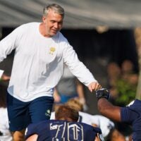 Notre Dame quarterbacks coach Gino Guidugli greets offensive lineman Aamil Wagner during a football practice at Irish Athletic Center on Friday, Aug. 15, 2025, in South Bend.