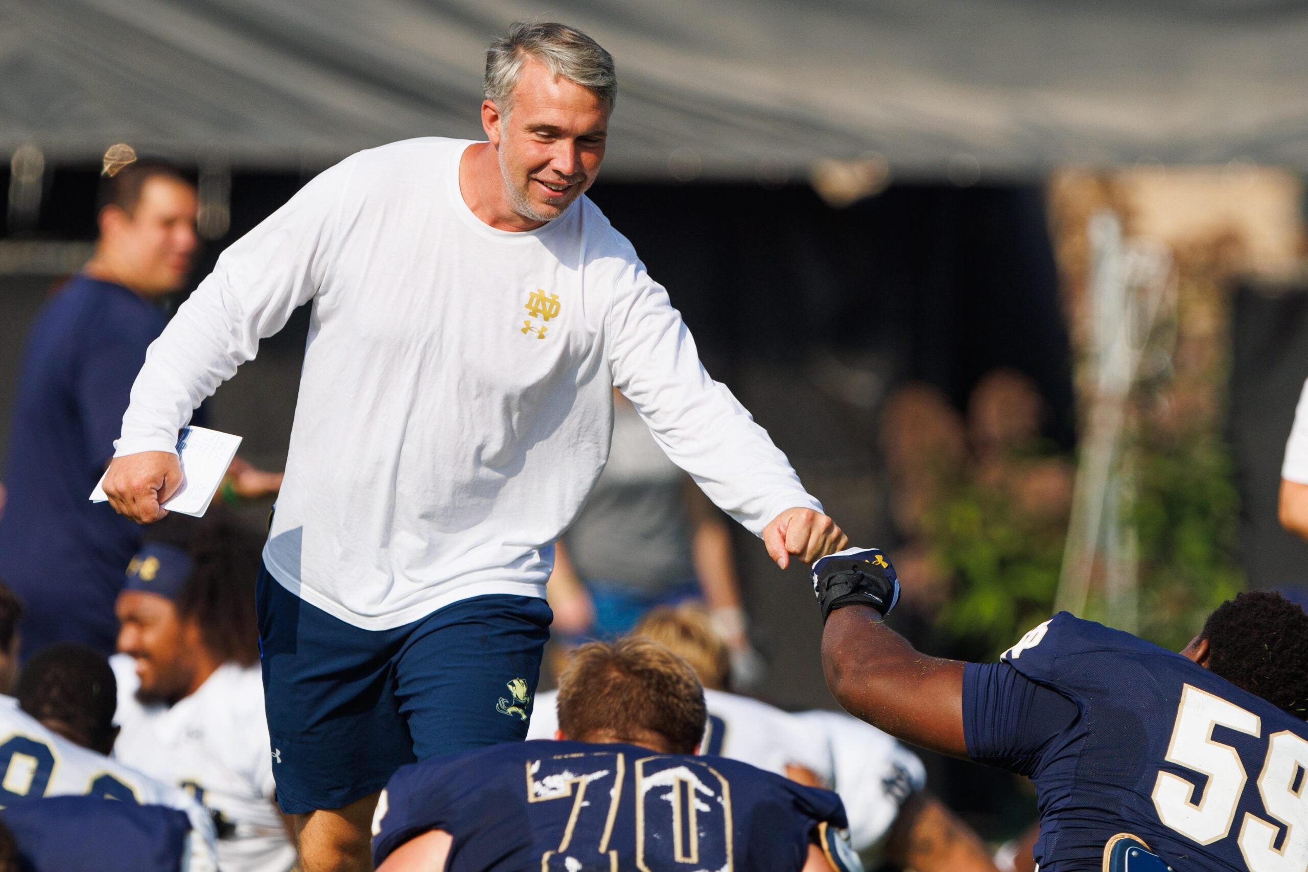 Notre Dame quarterbacks coach Gino Guidugli greets offensive lineman Aamil Wagner during a football practice at Irish Athletic Center on Friday, Aug. 15, 2025, in South Bend.
