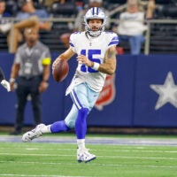 Aug 22, 2025; Arlington, Texas, USA; Dallas Cowboys quarterback Will Grier (15) scrambles with the ball during the fourth quarter against the Atlanta Falcons at AT&T Stadium.