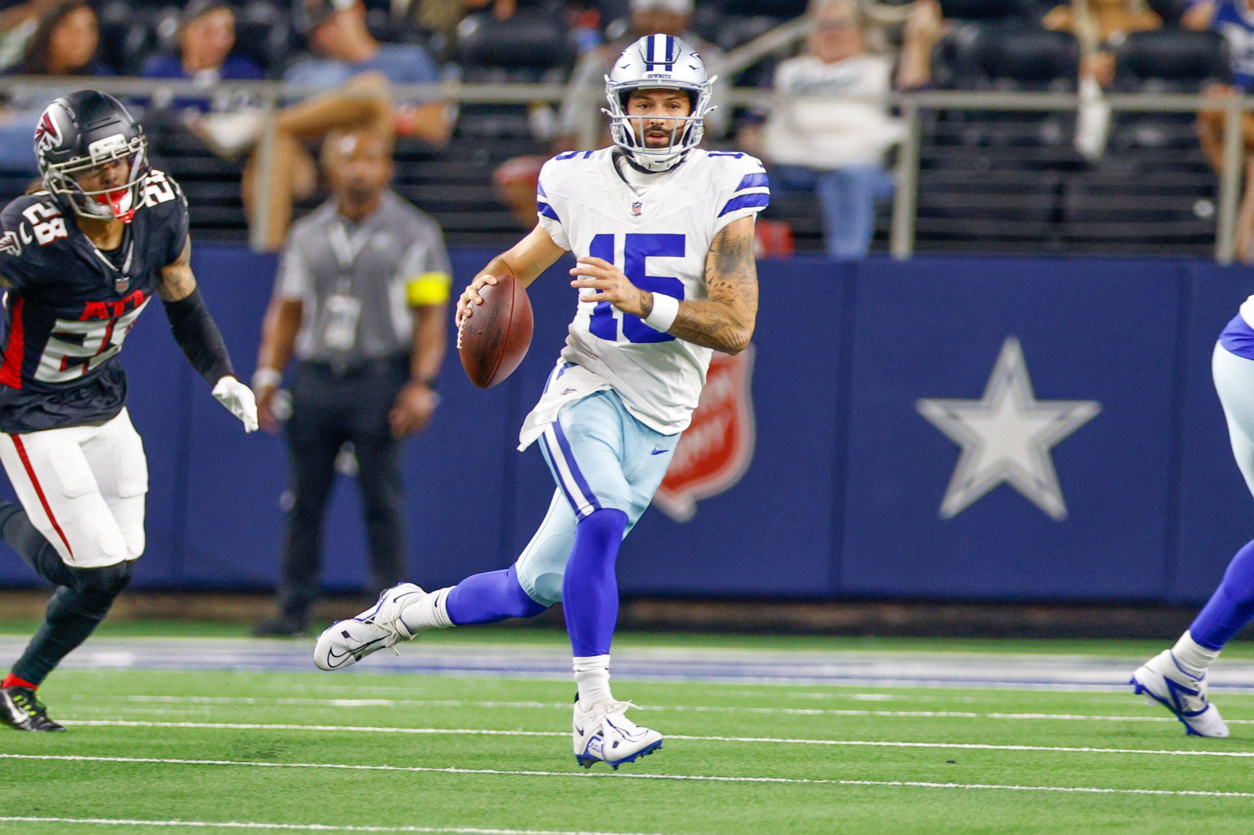 Aug 22, 2025; Arlington, Texas, USA; Dallas Cowboys quarterback Will Grier (15) scrambles with the ball during the fourth quarter against the Atlanta Falcons at AT&T Stadium.