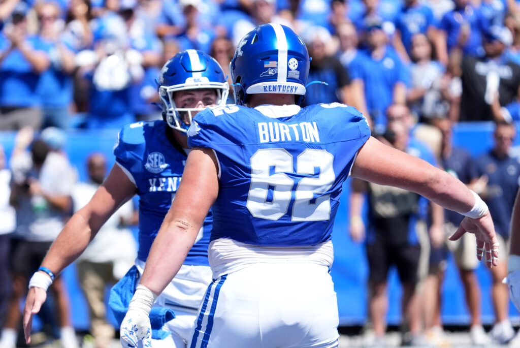Kentucky’s quarterback Zach Calzada (5) celebrates with teammate Jager Burton (62) scoring a touchdown against Toledo Saturday afternoon at Kroger Field.