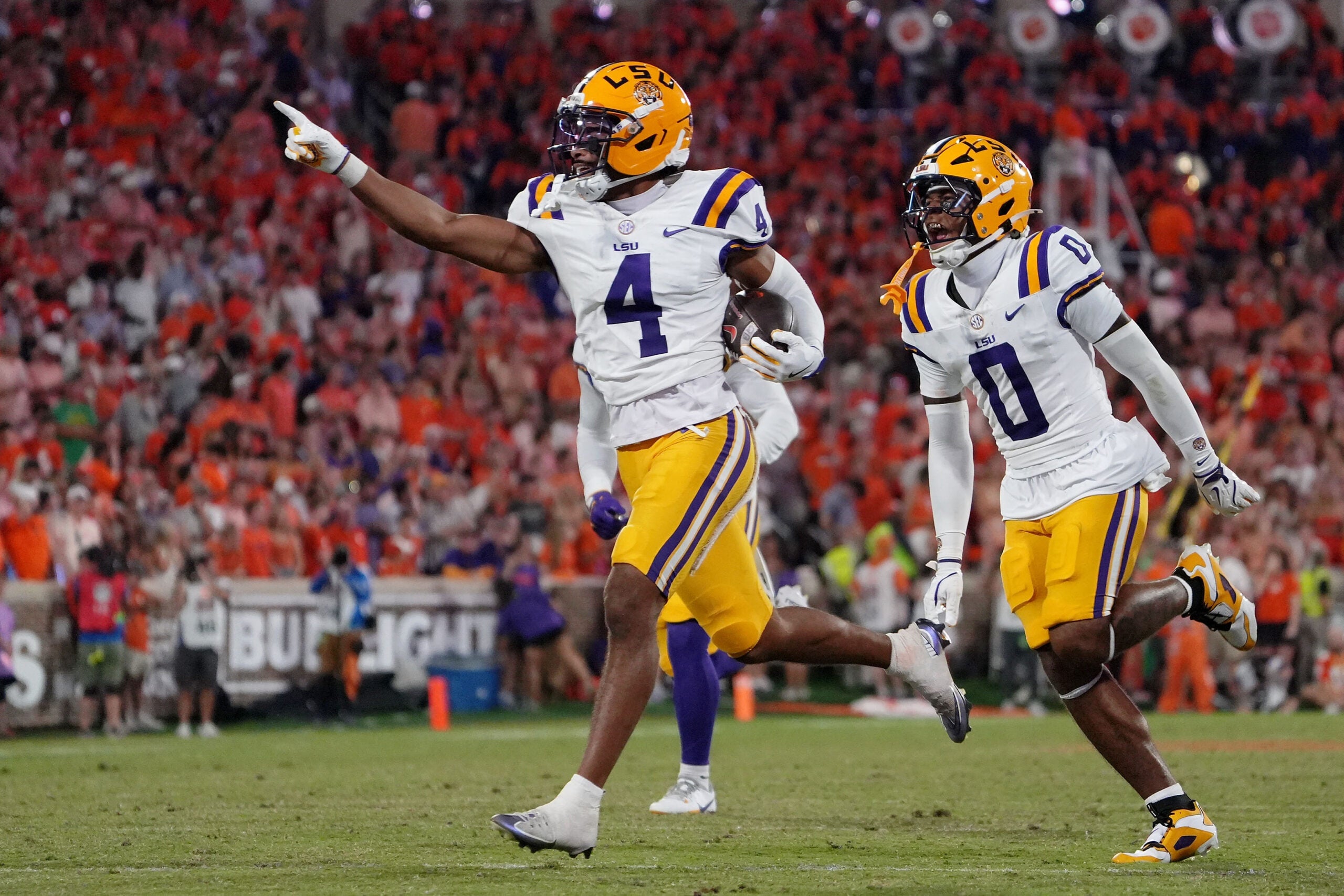 Aug 30, 2025; Clemson, South Carolina, USA; LSU Tigers cornerback Mansoor Delane (4) celebrates with safety Tamarcus Cooley (0) after a play against the Clemson Tigers during the second half at Memorial Stadium.