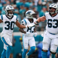 Sep 7, 2025; Jacksonville, Florida, USA; Carolina Panthers running back Chuba Hubbard (30) and center Austin Corbett (63) celebrate a touchdown against the Jacksonville Jaguars during the second half at EverBank Stadium.