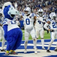 Colts defense celebrates a turnover with mascot Blue