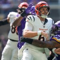 Cincinnati Bengals quarterback Jake Browning (6) is knocked down by Minnesota Vikings defensive tackle Jonathan Allen (93) as he gets a pass off in the second quarter of the NFL Week 3 game between the Minnesota Vikings and the Cincinnati Bengals at U.S. Bank Stadium in Minneapolis on Sunday, Sept. 21, 2025.