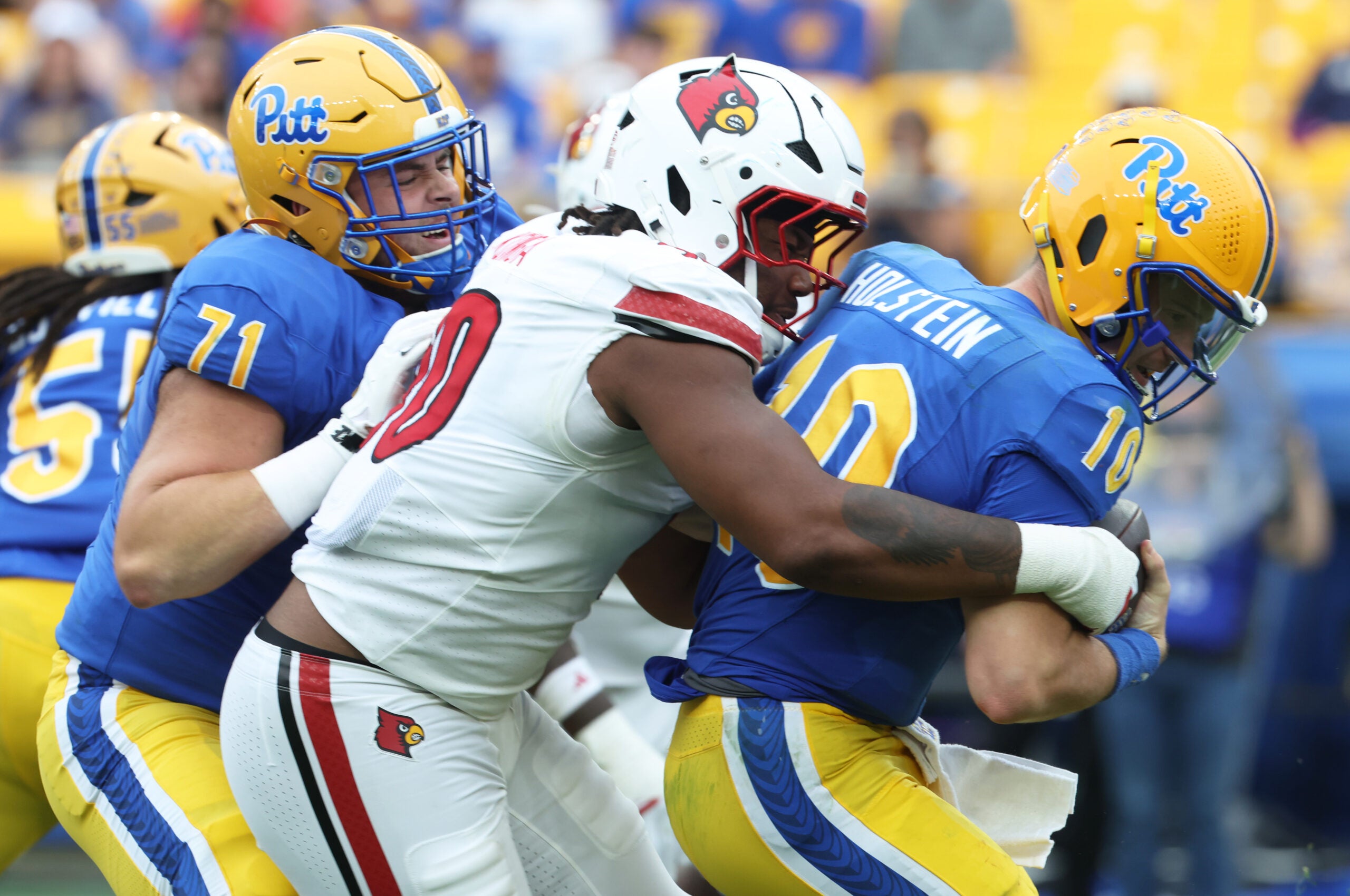 Sep 27, 2025; Pittsburgh, Pennsylvania, USA; Louisville Cardinals defensive lineman Rene Konga (90) sacks Pittsburgh Panthers quarterback Eli Holstein (10) during the fourth quarter at Acrisure Stadium.
