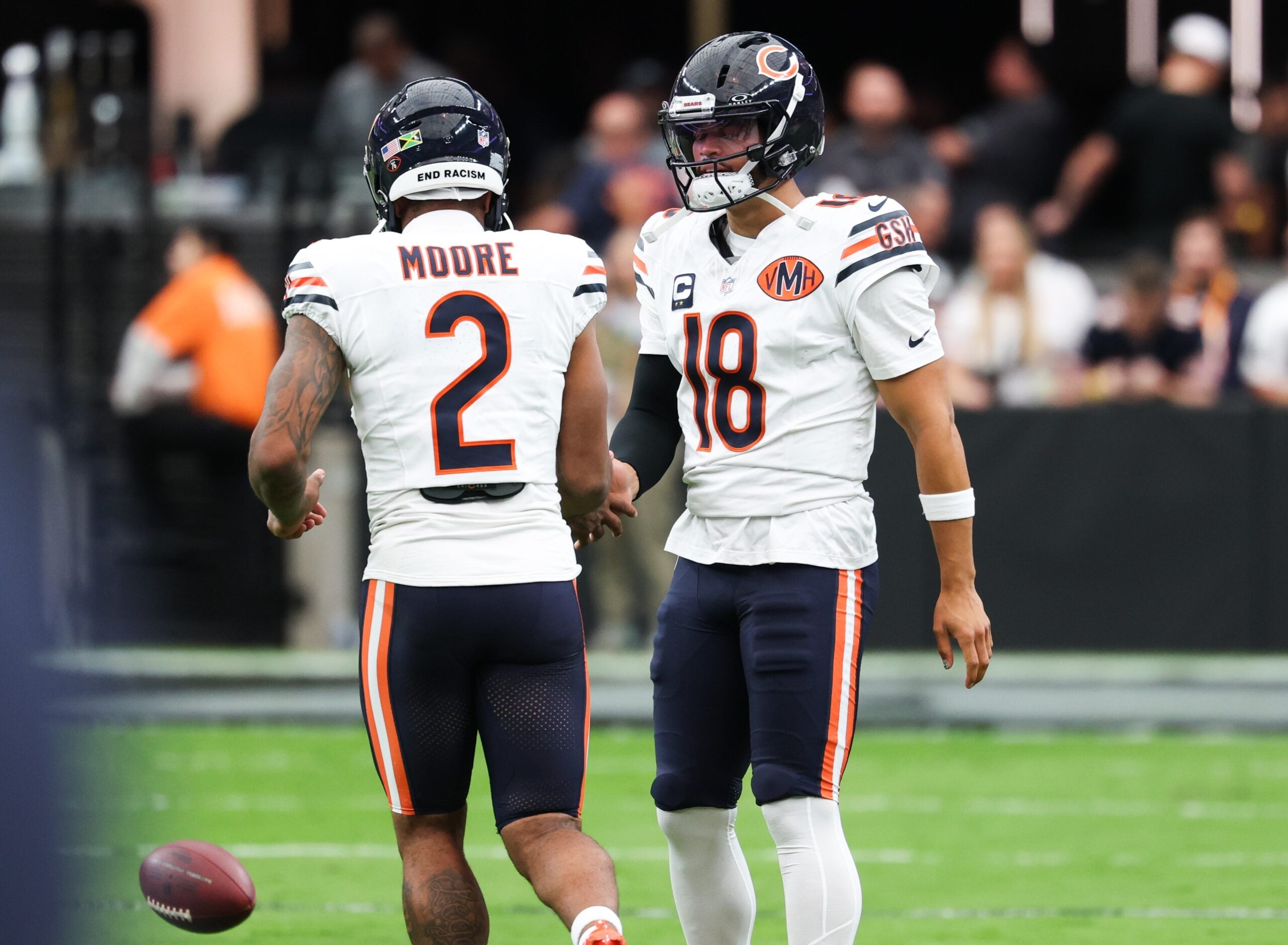 Sep 28, 2025; Paradise, Nevada, USA; Chicago Bears quarterback Caleb Williams (18) shakes hands with wide receiver DJ Moore (2) during warm ups prior to the game against the Las Vegas Raiders at Allegiant Stadium.