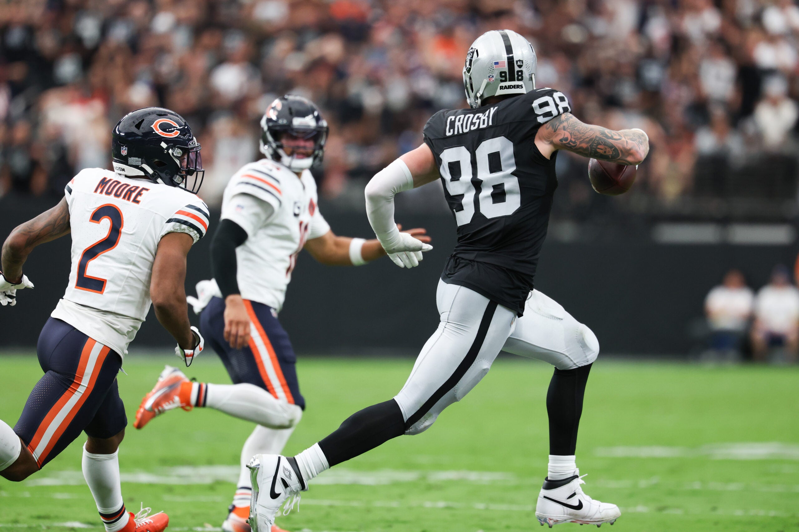 Sep 28, 2025; Paradise, Nevada, USA; Las Vegas Raiders defensive end Maxx Crosby (98) runs with the ball during the first quarter against the Chicago Bears at Allegiant Stadium.