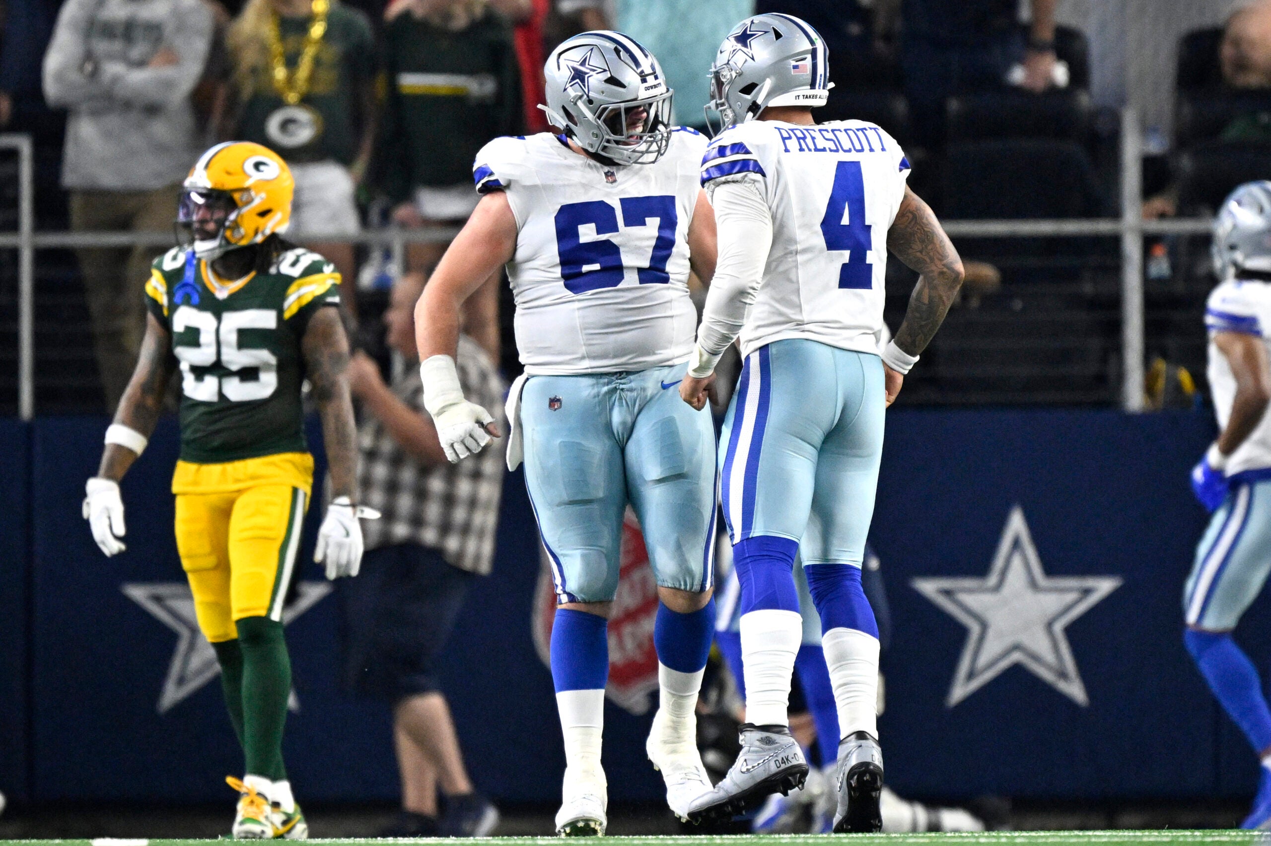 Sep 28, 2025; Arlington, Texas, USA; Dallas Cowboys quarterback Dak Prescott (4) celebrates with center Brock Hoffman (67) after a touchdown in the second quarter against the Green Bay Packers at AT&T Stadium.
