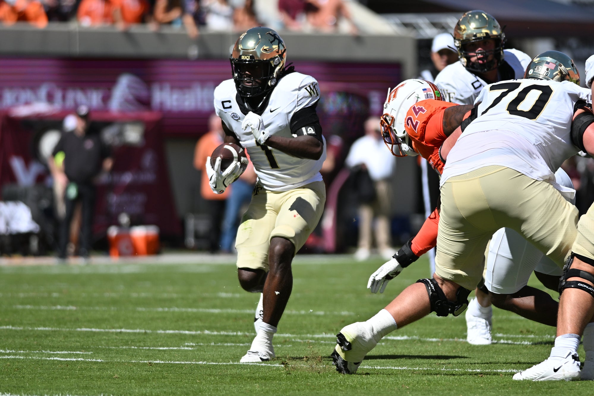 Oct 4, 2025; Blacksburg, Virginia, USA; Wake Forest Demon Deacons running back Demond Claiborne (1) runs the ball during the first quarter against the Virginia Tech Hokies at Lane Stadium. Mandatory Credit: Brian Bishop-Imagn Images