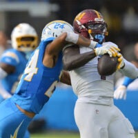 Oct 5, 2025; Inglewood, California, USA; Washington Commanders wide receiver Deebo Samuel Sr. (1) makes a catch against Los Angeles Chargers cornerback Benjamin St-Juste (24) in the second half at SoFi Stadium.