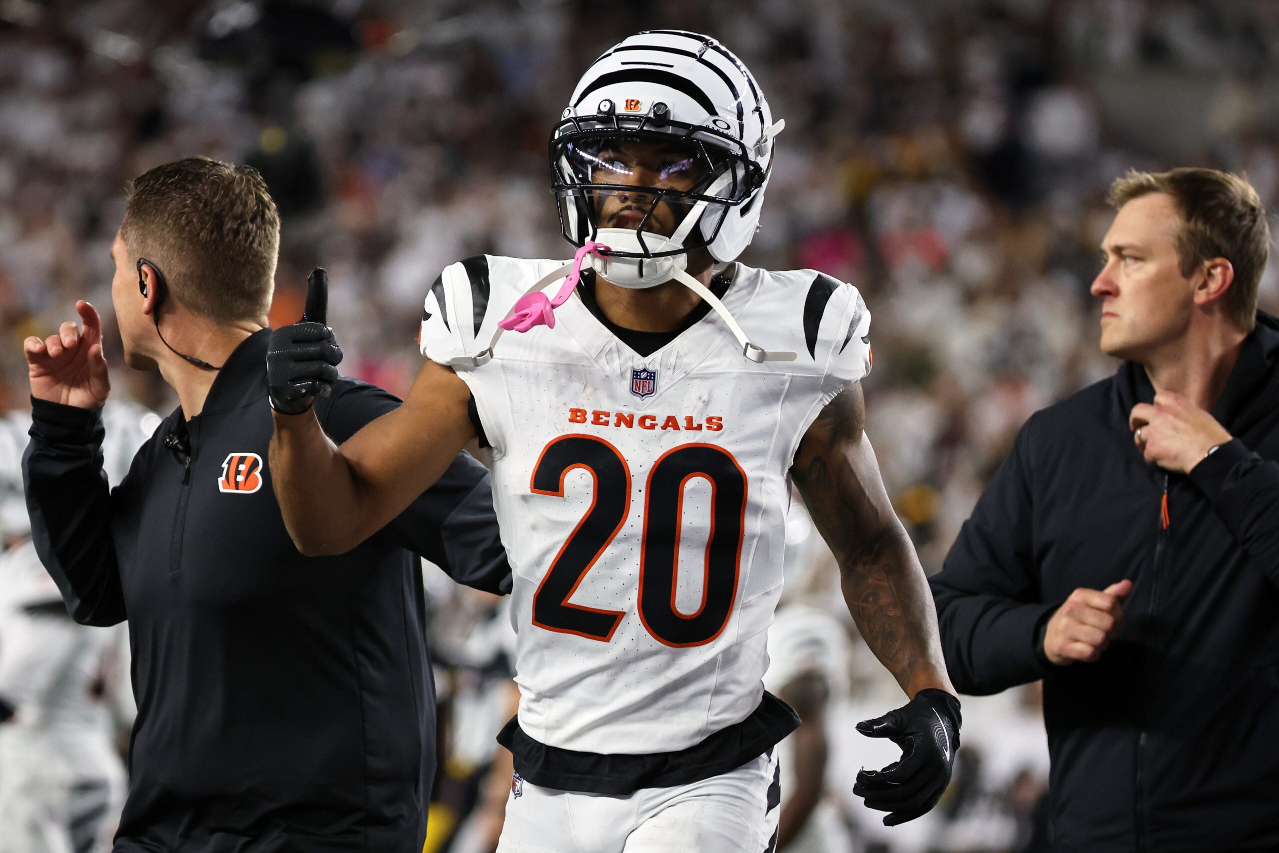 Oct 16, 2025; Cincinnati, Ohio, USA; Cincinnati Bengals cornerback DJ Turner II (20) gestures toward his bench as he walks off the field with an apparent injury against the Pittsburgh Steelers during the third quarter at Paycor Stadium.
