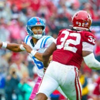 Oct 25, 2025; Norman, Oklahoma, USA; Ole Miss Rebels quarterback Trinidad Chambliss (6) throws as Oklahoma Sooners defensive lineman R Mason Thomas (32) defends during the first half at Gaylord Family-Oklahoma Memorial Stadium. Mandatory Credit: Kevin Jairaj-Imagn Images