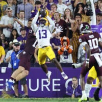 Oct 25, 2025; Baton Rouge, Louisiana, USA; Louisiana State Tigers defensive back A.J. Haulcy (13) makes an interception against Texas A&M Aggies tight end Theo Melin Öhrström (17) during the first half at Tiger Stadium.