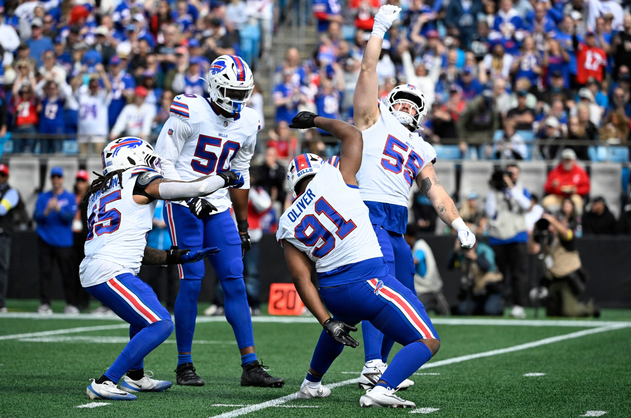 Oct 26, 2025; Charlotte, North Carolina, USA; Buffalo Bills linebacker Shaq Thompson (45), defensive end Greg Rousseau (50), defensive tackle Ed Oliver (91) and defensive end Michael Hoecht (55) celebrate after a sack during the first half against the Carolina Panthers at Bank of America Stadium.