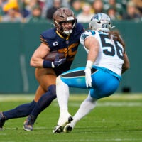 Nov 2, 2025; Green Bay, Wisconsin, USA; Green Bay Packers tight end Tucker Kraft (85) runs after a catch against Carolina Panthers linebacker Christian Rozeboom (56) during the first half at Lambeau Field.