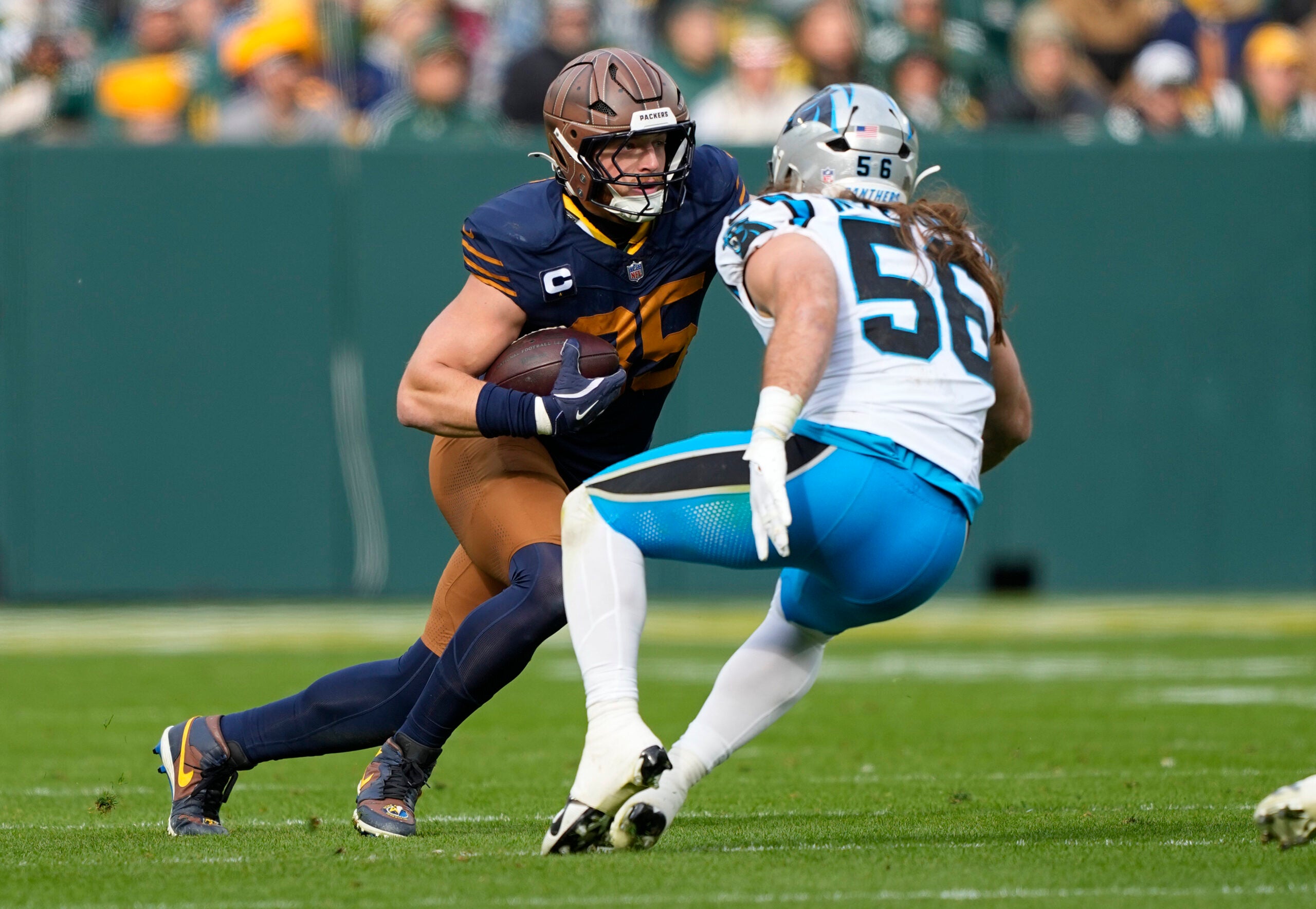 Nov 2, 2025; Green Bay, Wisconsin, USA; Green Bay Packers tight end Tucker Kraft (85) runs after a catch against Carolina Panthers linebacker Christian Rozeboom (56) during the first half at Lambeau Field.