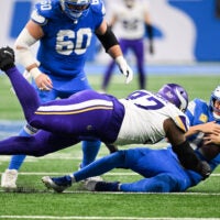 Nov 2, 2025; Detroit, Michigan, USA; Detroit Lions quarterback Jared Goff (16) is brought down by Minnesota Vikings defensive lineman Javon Hargrave (97) in the third quarter at Ford Field.