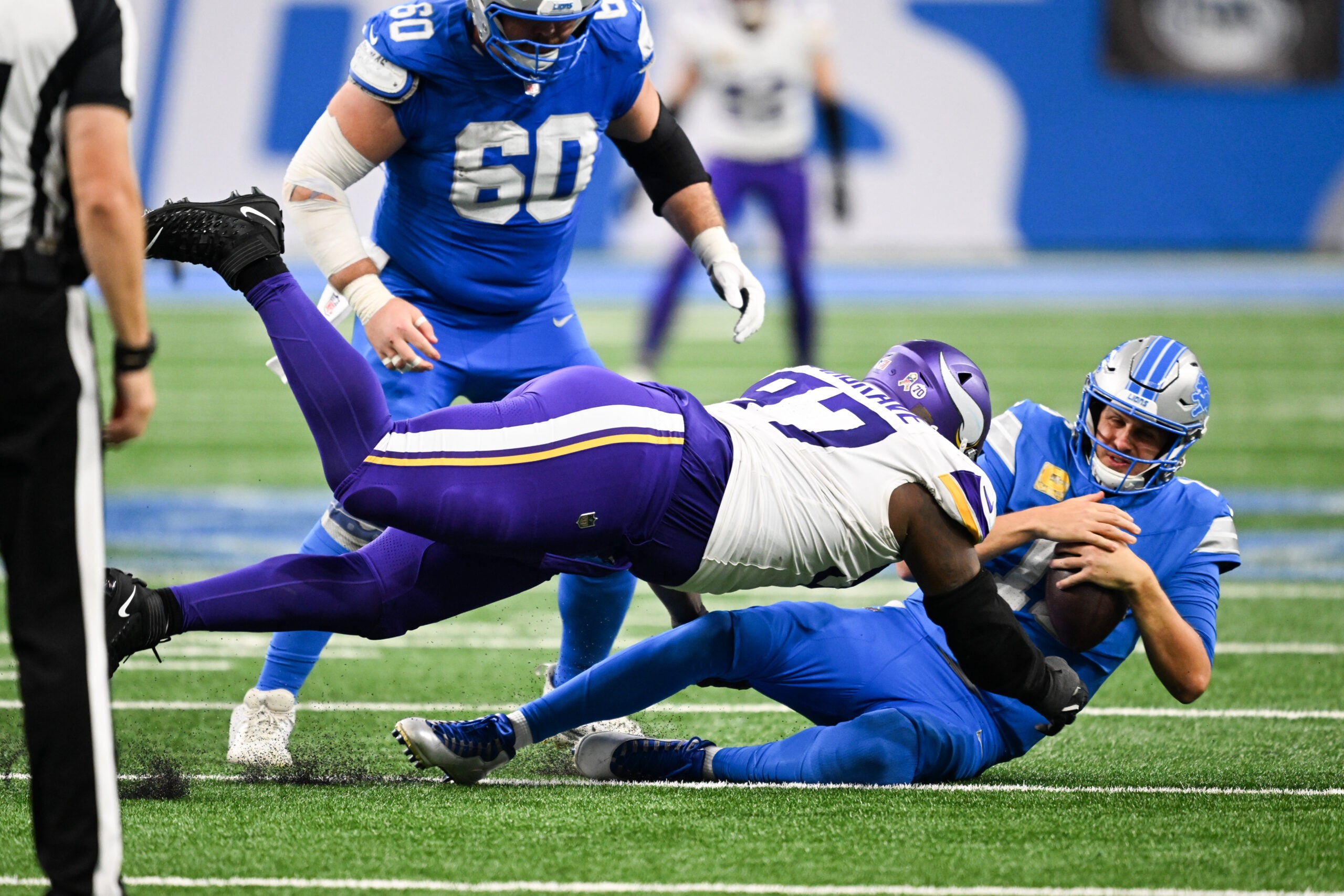 Nov 2, 2025; Detroit, Michigan, USA; Detroit Lions quarterback Jared Goff (16) is brought down by Minnesota Vikings defensive lineman Javon Hargrave (97) in the third quarter at Ford Field.