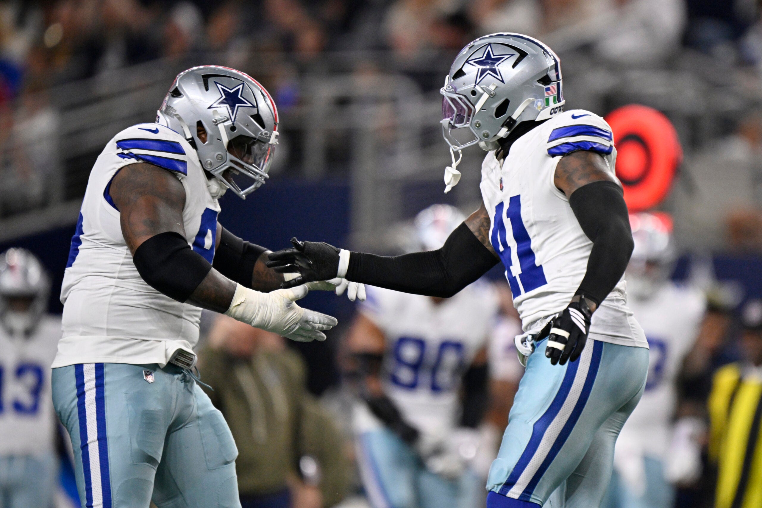 Nov 3, 2025; Arlington, Texas, USA; Dallas Cowboys defensive tackle Kenny Clark (95) celebrates with defensive end Donovan Ezeiruaku (41) after a sack against Arizona Cardinals quarterback Jacoby Brissett (7) in the second half at AT&T Stadium.