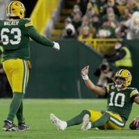 Green Bay Packers quarterback Jordan Love (10) is helped off the turf by offensive tackle Rasheed Walker (63) after being sacked during the first quarter of their game against the Philadelphia Eagles Monday, November 10, 2025 at Lambeau Field in Green Bay, Wisconsin.
