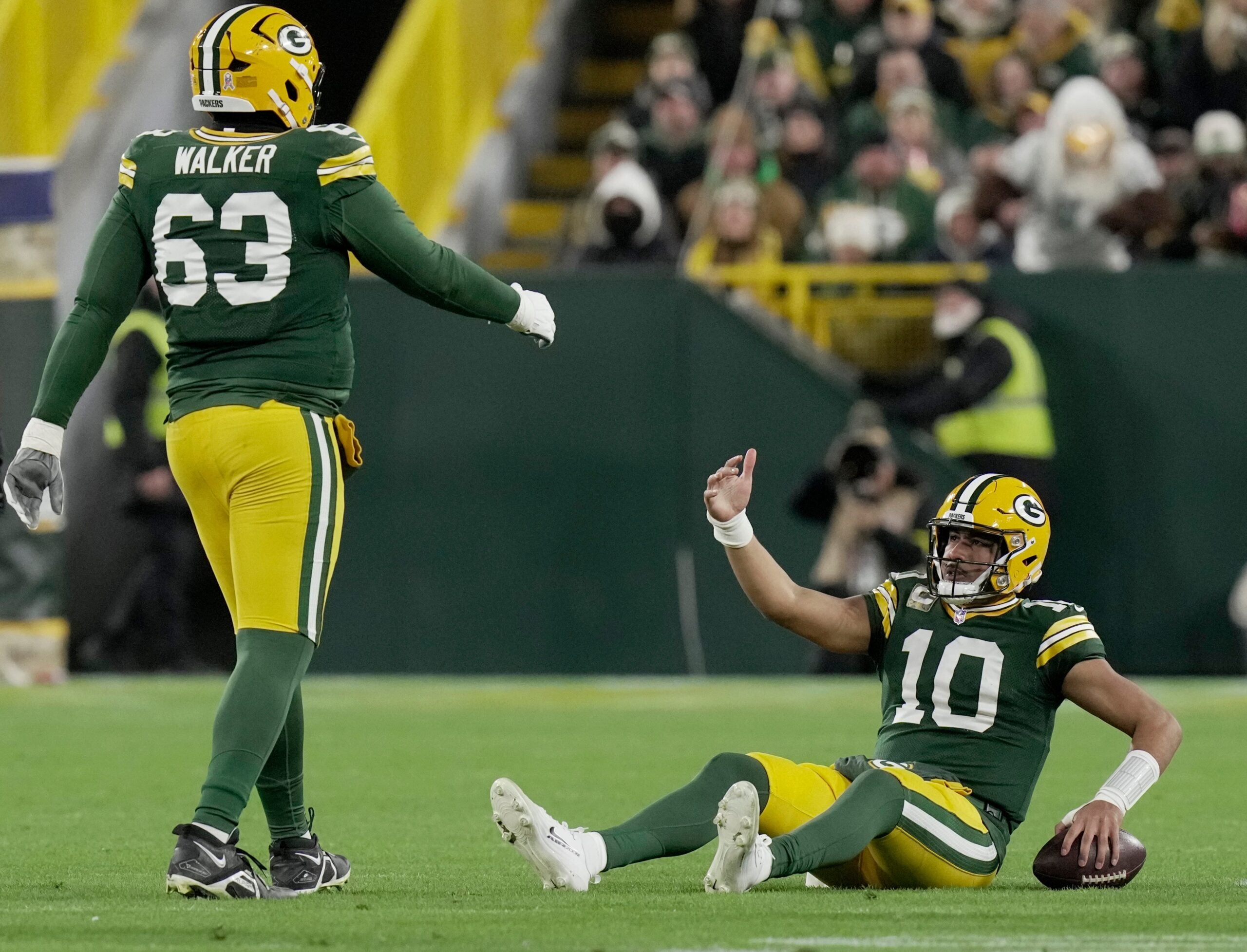 Green Bay Packers quarterback Jordan Love (10) is helped off the turf by offensive tackle Rasheed Walker (63) after being sacked during the first quarter of their game against the Philadelphia Eagles Monday, November 10, 2025 at Lambeau Field in Green Bay, Wisconsin.