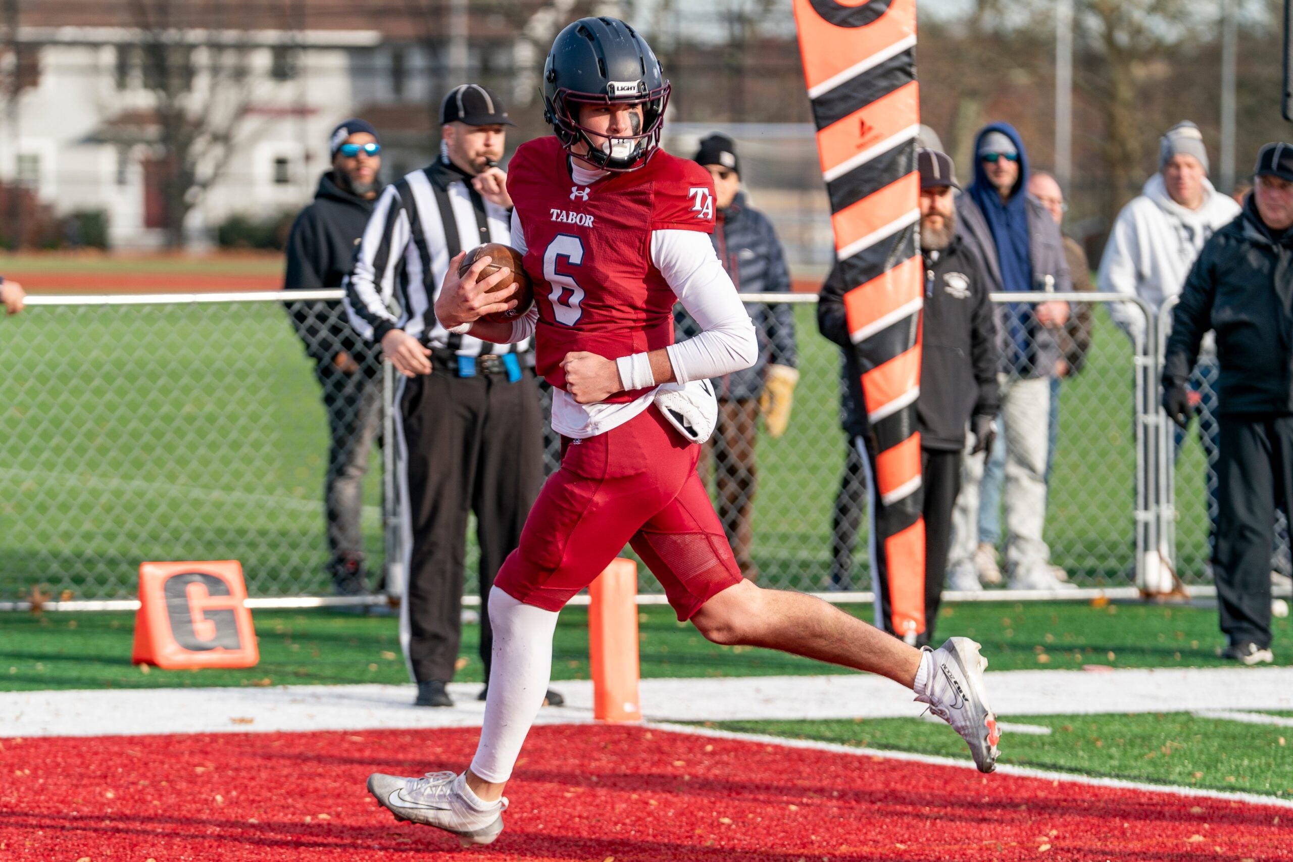 Tabor Academy's quarterback Peter Bourque looks back as he slips into the end zone unchallenged.
