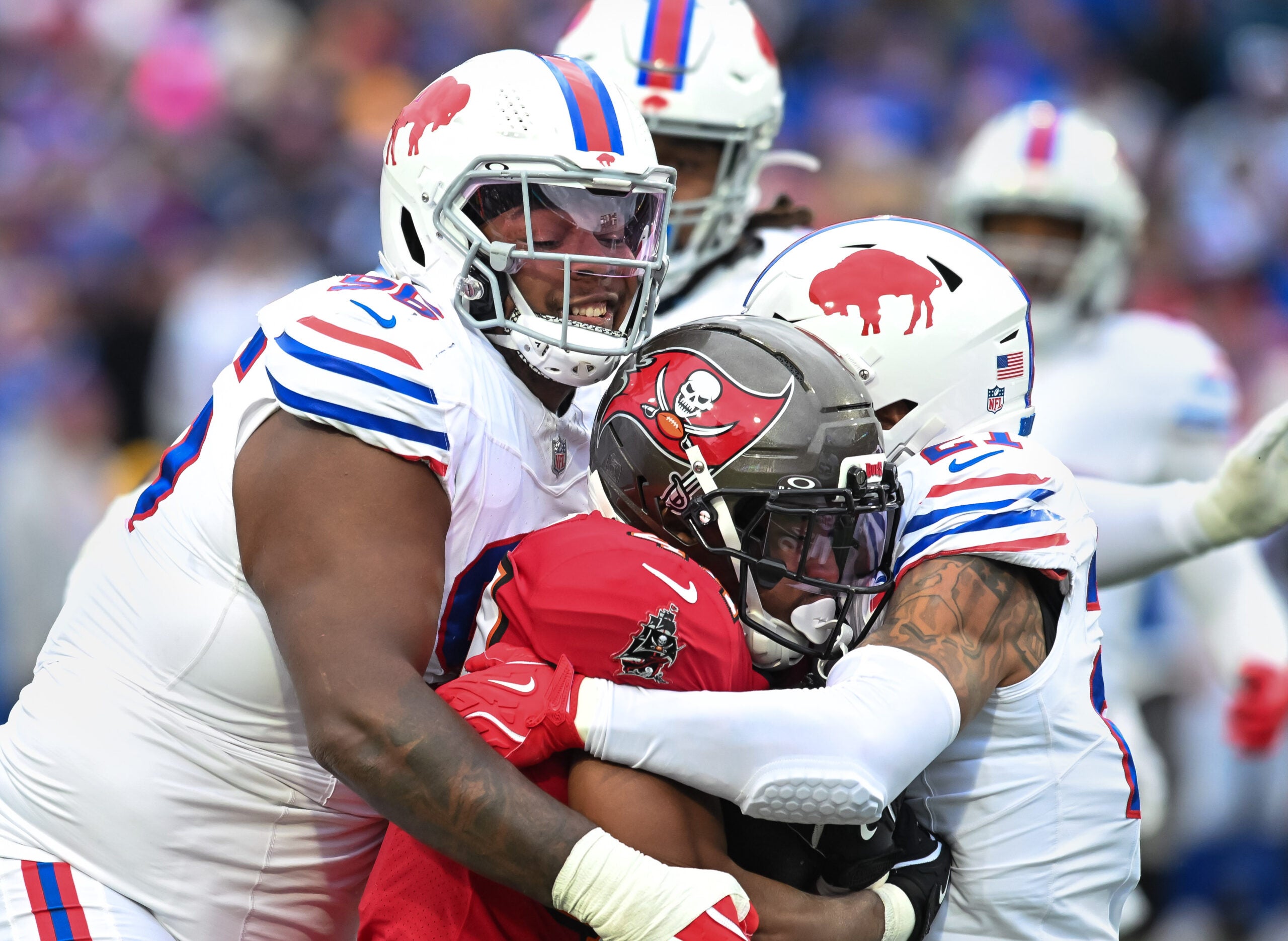 Nov 16, 2025; Orchard Park, New York, USA; Buffalo Bills defensive tackle Deone Walker (96) and safety Jordan Poyer (21) tackle Tampa Bay Buccaneers running back Sean Tucker (44) in the first quarter at Highmark Stadium.