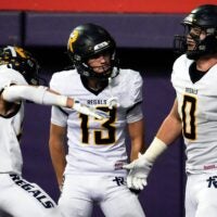 Iowa City Regina’s Tate Wallace (0) celebrates with teammates after scoring a touchdown Nov. 20, 2025 during the Class 1A state football championship against the West Lyon Wildcats at the UNI-Dome in Cedar Falls, Iowa.