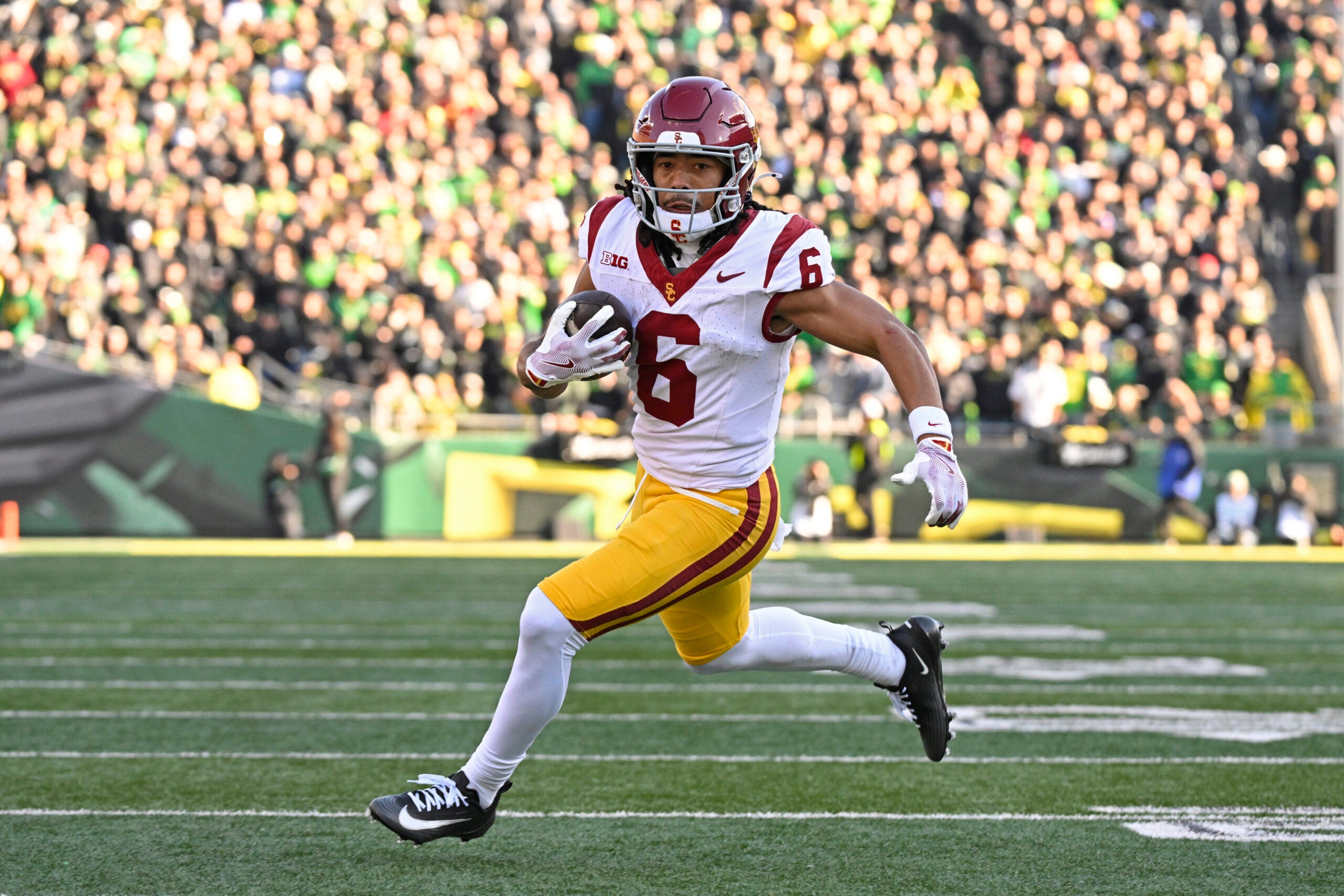 Nov 22, 2025; Eugene, Oregon, USA; Southern California Trojans wide receiver Makai Lemon (6) runs with the ball during the first half against the Oregon Ducks at Autzen Stadium.