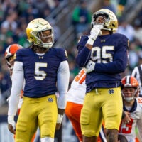 Nov 22, 2025; South Bend, Indiana, USA; Notre Dame Fighting Irish defensive lineman Bryce Young (95) celebrates a stop along side defensive lineman Boubacar Traore (5) against the Syracuse Orange during the first half at Notre Dame Stadium. Mandatory Credit: Michael Caterina-Imagn Images