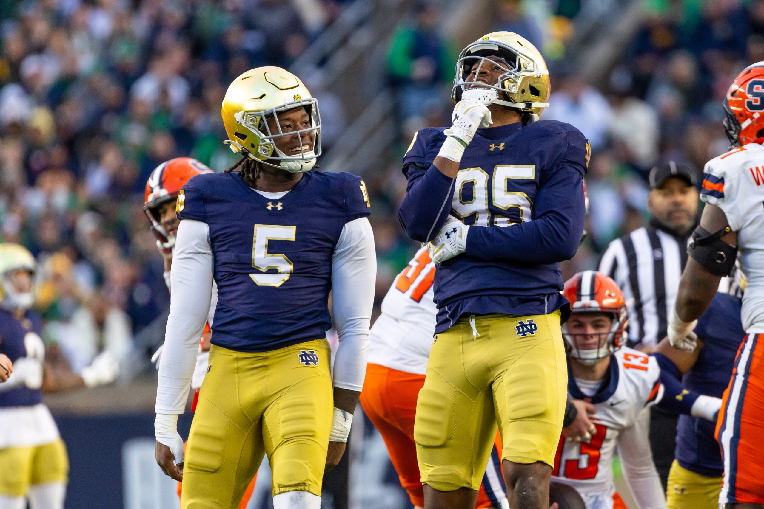Nov 22, 2025; South Bend, Indiana, USA; Notre Dame Fighting Irish defensive lineman Bryce Young (95) celebrates a stop along side defensive lineman Boubacar Traore (5) against the Syracuse Orange during the first half at Notre Dame Stadium. Mandatory Credit: Michael Caterina-Imagn Images