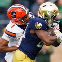 Notre Dame running back Jadarian Price, right, runs the ball into the end zone for a touchdown with Syracuse defensive back Demetres Samuel Jr. (1) attempting the tackled in the first half of a NCAA football game at Notre Dame Stadium on Saturday, Nov. 22, 2025, in South Bend.