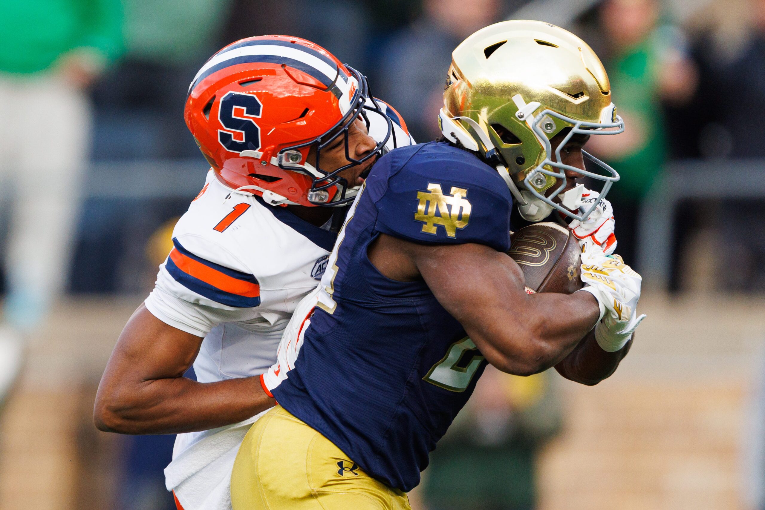 Notre Dame running back Jadarian Price, right, runs the ball into the end zone for a touchdown with Syracuse defensive back Demetres Samuel Jr. (1) attempting the tackled in the first half of a NCAA football game at Notre Dame Stadium on Saturday, Nov. 22, 2025, in South Bend.