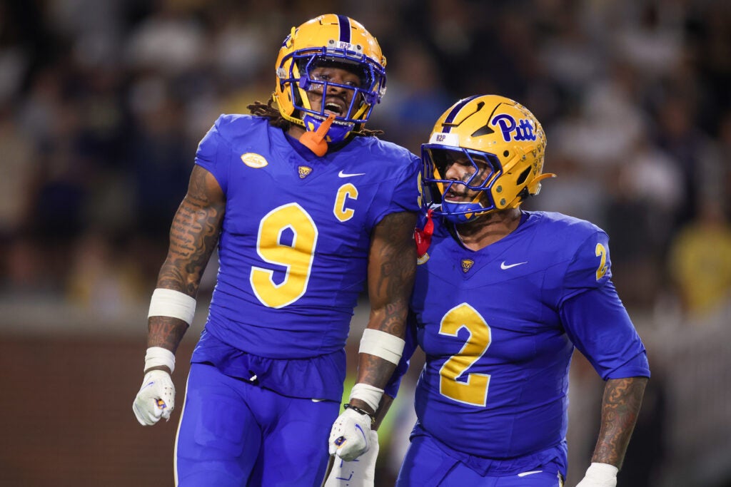 Nov 22, 2025; Atlanta, Georgia, USA; Pittsburgh Panthers linebacker Kyle Louis (9) reacts after a sack with defensive lineman Isaiah Neal (2) against the Georgia Tech Yellow Jackets in the first quarter at Bobby Dodd Stadium at Hyundai Field. 