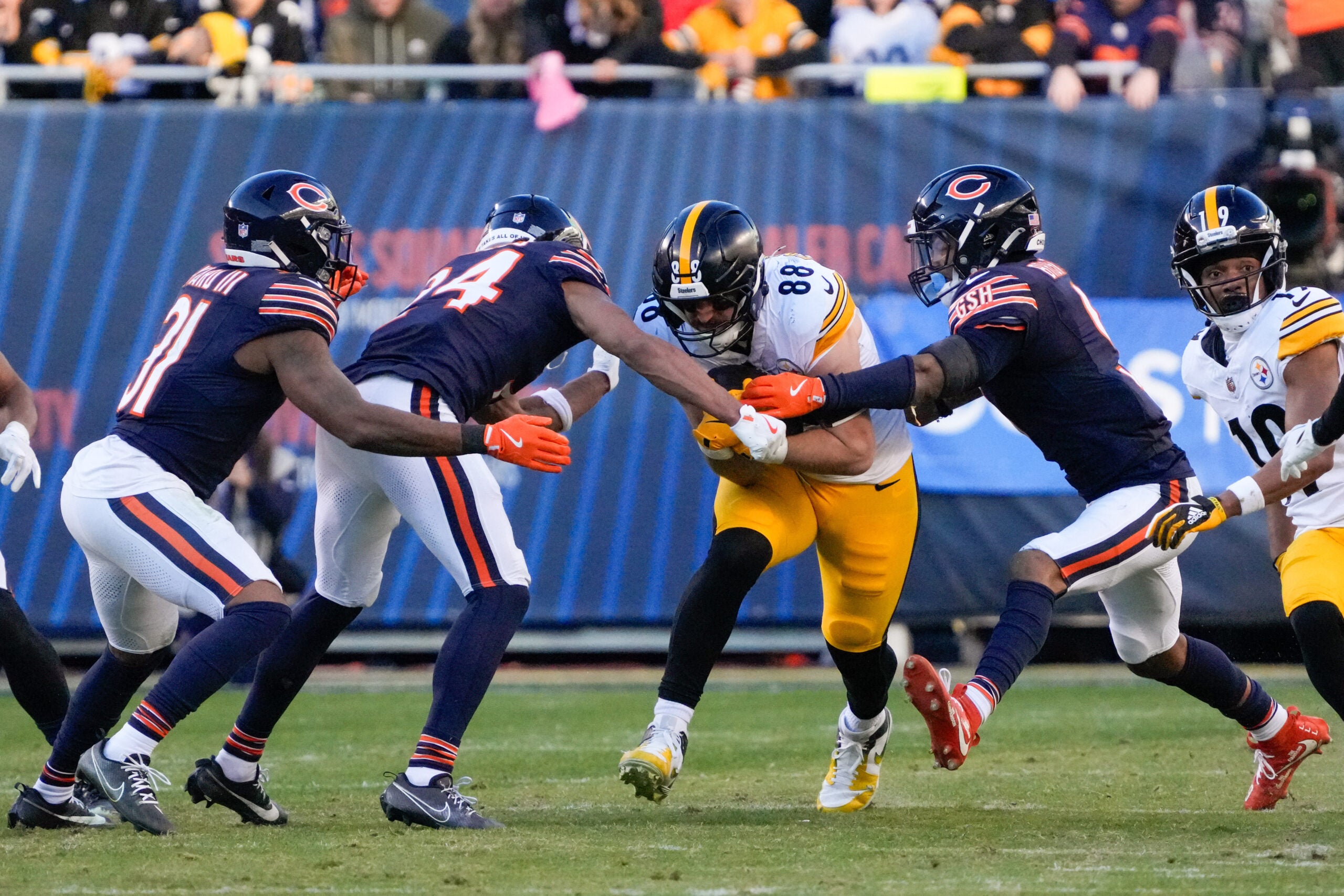 Nov 23, 2025; Chicago, Illinois, USA; Pittsburgh Steelers tight end Pat Freiermuth (88) runs after the catch as Chicago Bears safety Jaquan Brisker (9) and cornerback Nick McCloud (24) defend during the second half at Soldier Field.