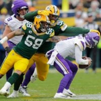 Green Bay Packers' Isaiah McDuffie (58) and Warren Brinson (91) sack Minnesota Vikings quarterback J.J. McCarthy (9) in the second quarter during their football game Sunday, November 23, 2025, at Lambeau Field in Green Bay, Wisconsin.