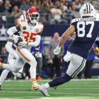 Nov 27, 2025; Arlington, Texas, USA; Kansas City Chiefs cornerback Jaylen Watson (35) returns an interception against Dallas Cowboys tight end Jake Ferguson (87) at AT&T Stadium.