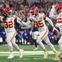 Nov 27, 2025; Arlington, Texas, USA; Kansas City Chiefs linebacker Nick Bolton (32) and Kansas City Chiefs cornerback Jaylen Watson (35) celebrate after an interception against the Dallas Cowboys during the first quarter at AT&T Stadium.