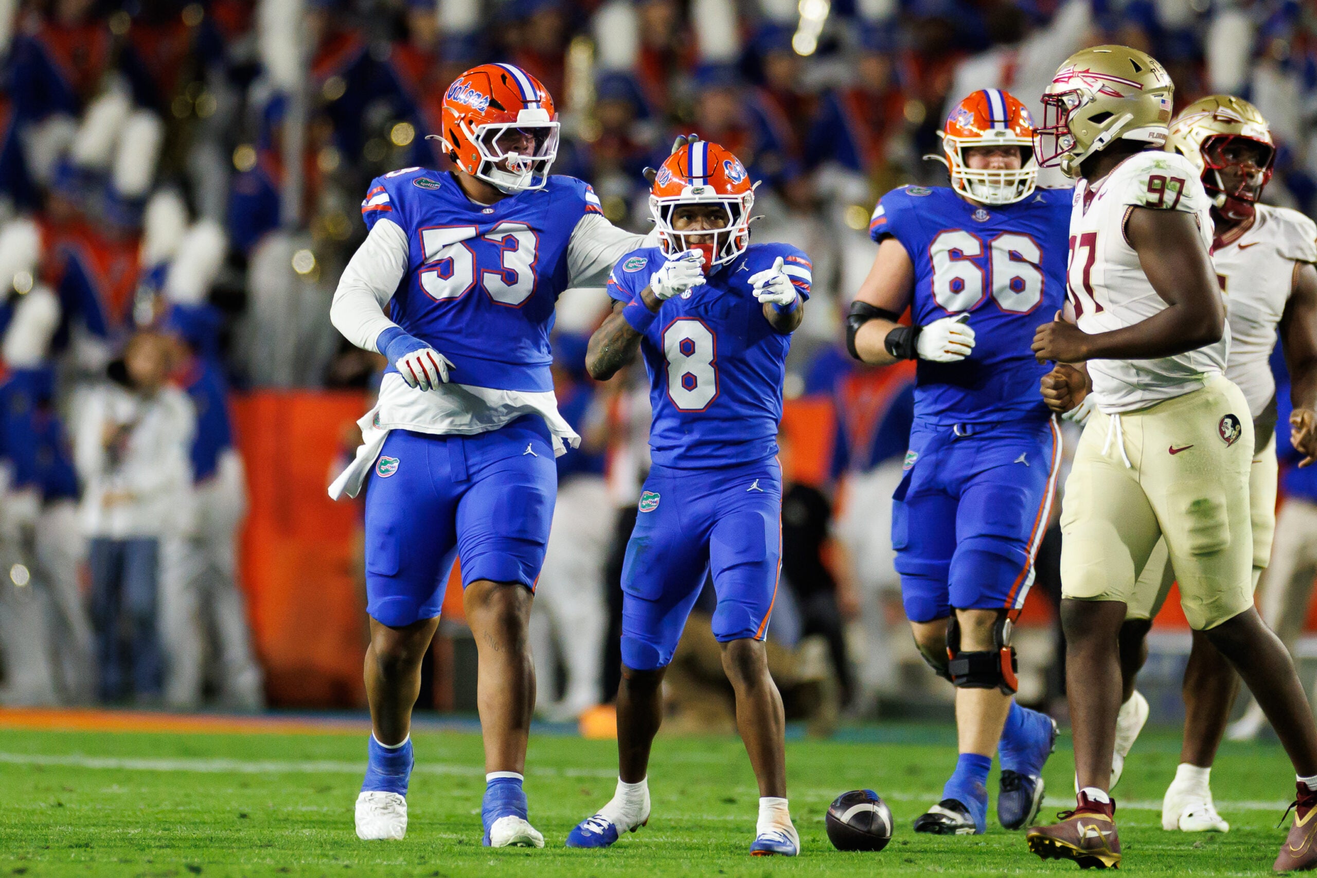 Nov 29, 2025; Gainesville, Florida, USA; Florida Gators wide receiver Vernell Brown III (8) gestures with Florida Gators offensive lineman Bryce Lovett (53) and Florida Gators offensive lineman Jake Slaughter (66) after a first down against the Florida State Seminoles during the first half at Ben Hill Griffin Stadium.