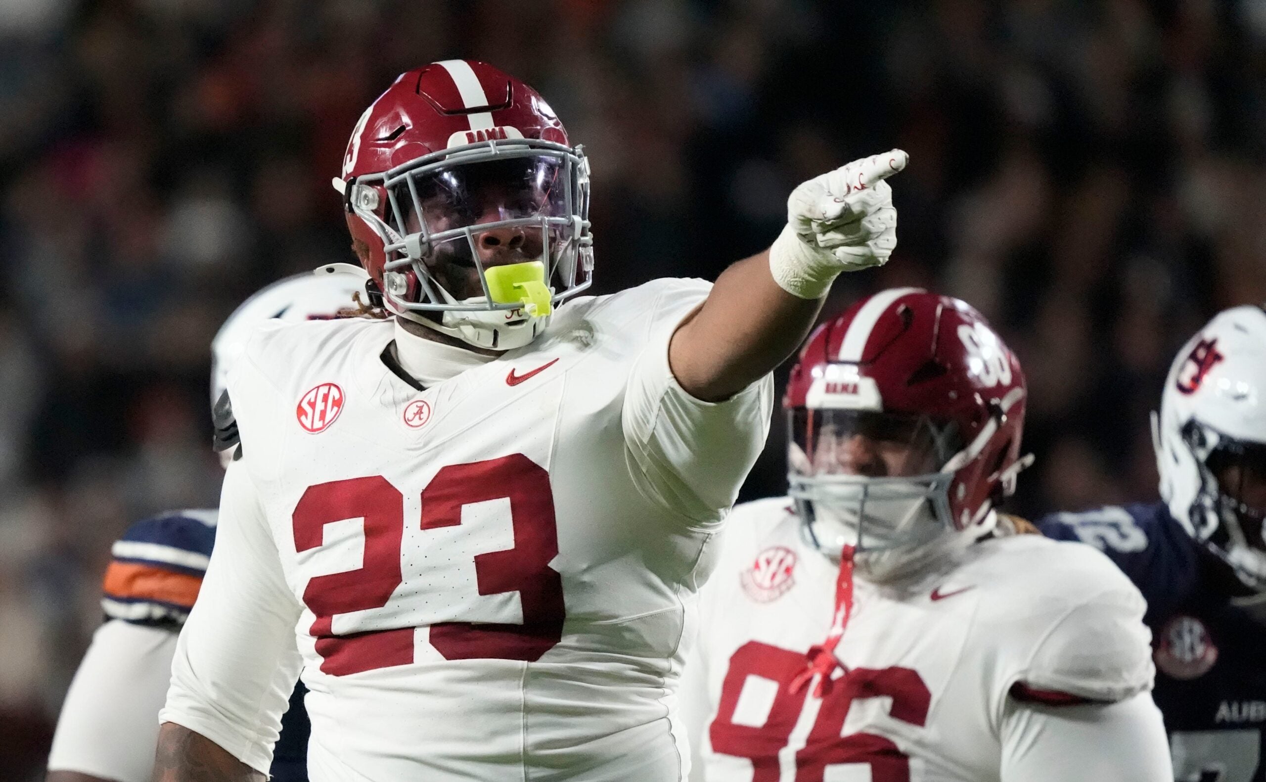Nov 29, 2025; Auburn, Alabama, USA; Alabama defensive lineman James Smith (23) celebrates his sack of Auburn quarterback Ashton Daniels (12) at Jordan-Hare Stadium.