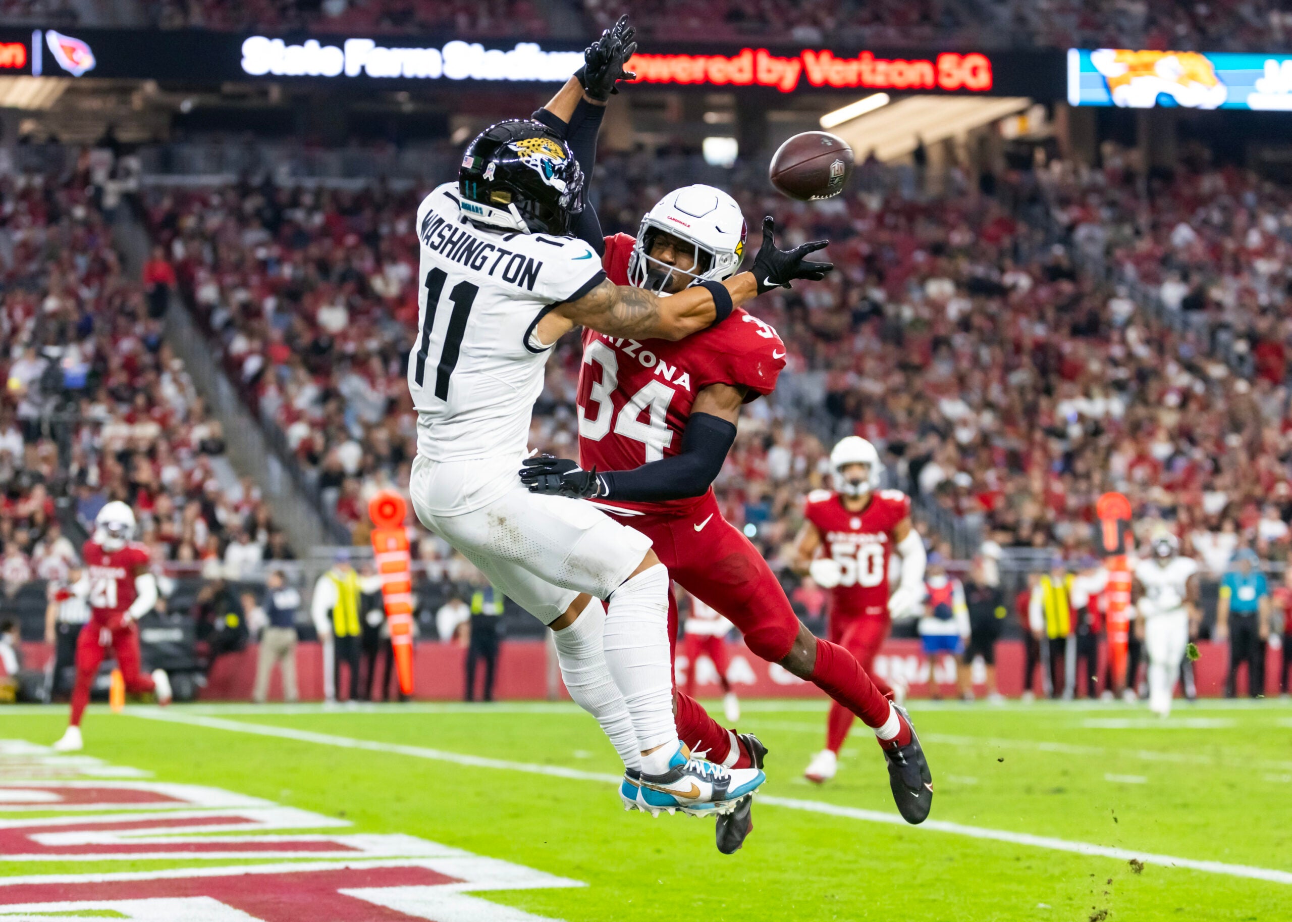 Arizona Cardinals safety Jalen Thompson (34) breaks up a pass to Jacksonville Jaguars wide receiver Parker Washington (11) at State Farm Stadium.