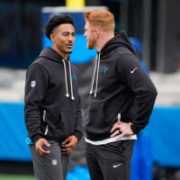Nov 30, 2025; Charlotte, North Carolina, USA; Carolina Panthers quarterback Bryce Young (9) and Carolina Panthers quarterback Andy Dalton (14) speak before the game against the Los Angeles Rams at Bank of America Stadium.