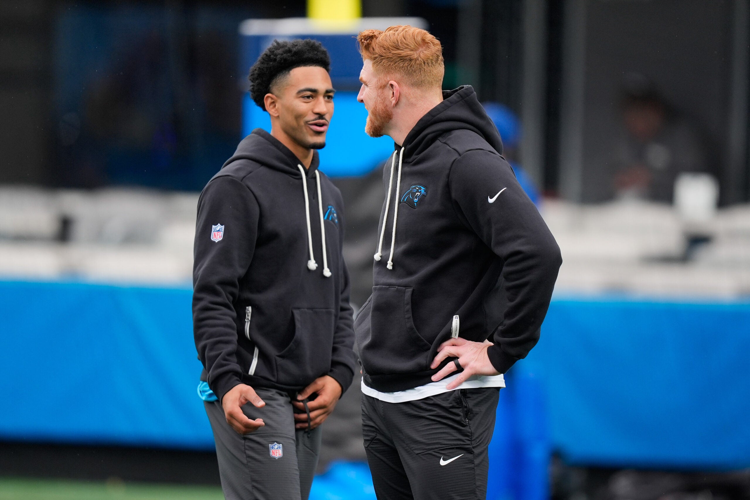 Nov 30, 2025; Charlotte, North Carolina, USA; Carolina Panthers quarterback Bryce Young (9) and Carolina Panthers quarterback Andy Dalton (14) speak before the game against the Los Angeles Rams at Bank of America Stadium.