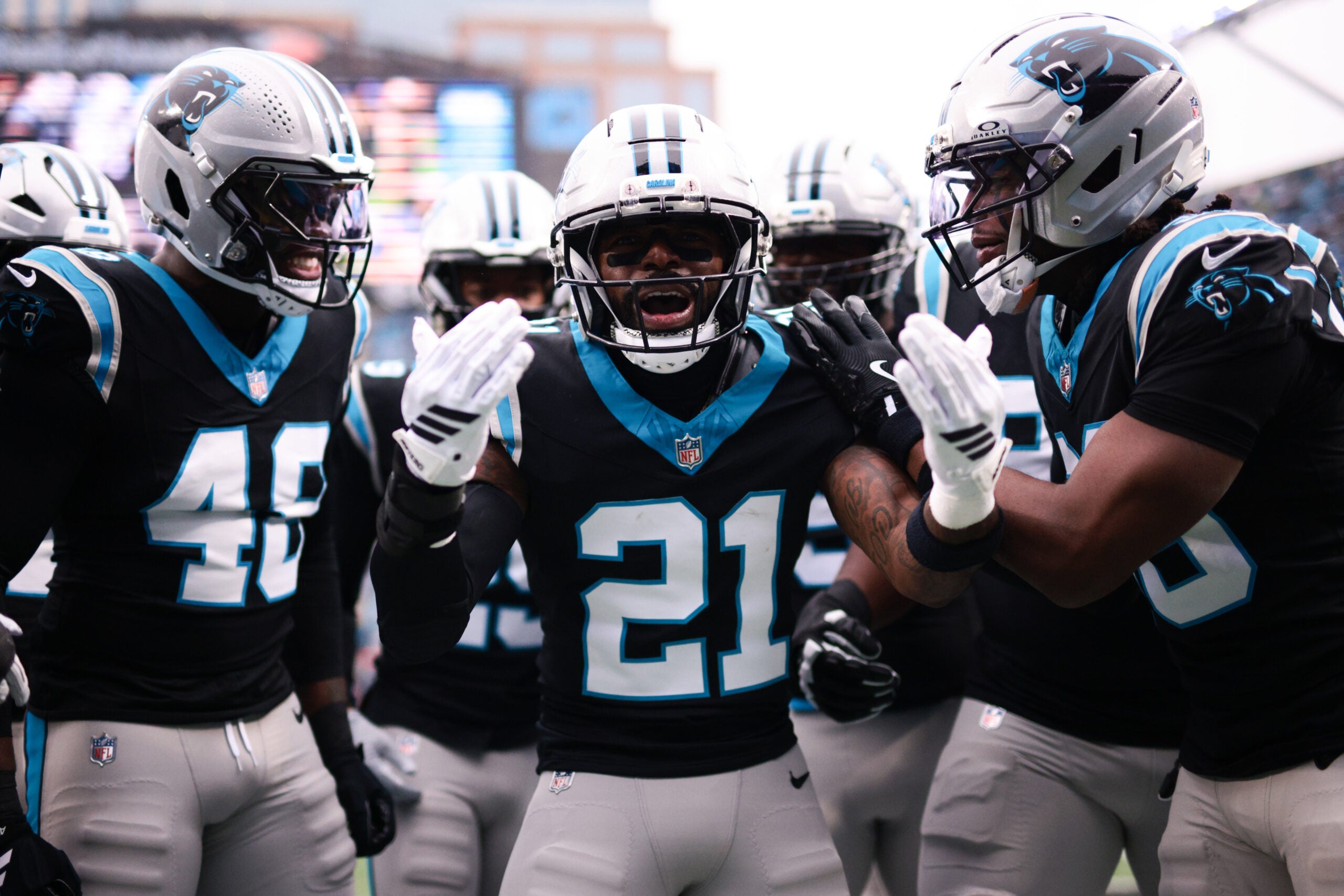 Nov 30, 2025; Charlotte, North Carolina, USA; Carolina Panthers safety Nick Scott (21) celebrates a defensive touchdown scored by Carolina Panthers cornerback Mike Jackson (2) (not pictured) during the first quarter against the Los Angeles Rams at Bank of America Stadium.