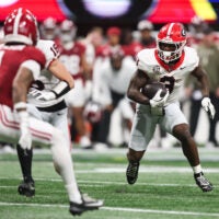 Dec 6, 2025; Atlanta, GA, USA; Georgia Bulldogs running back Nate Frazier (3) rushes as Alabama Crimson Tide defensive back Domani Jackson (1) defends during the third quarter during the 2025 SEC Championship game at Mercedes-Benz Stadium.
